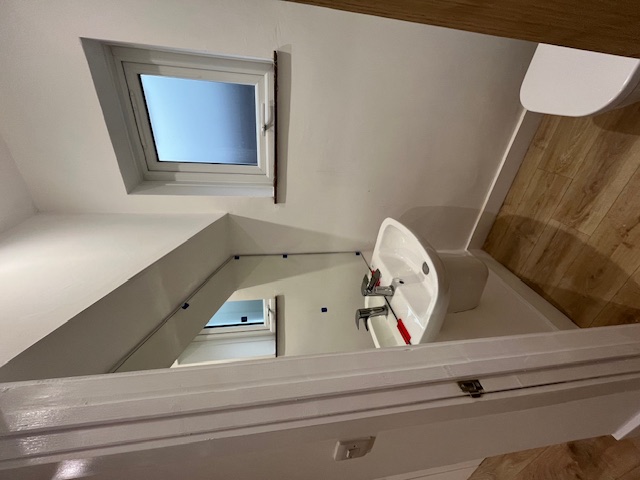 After - clean renovated bathroom with pedestal sink