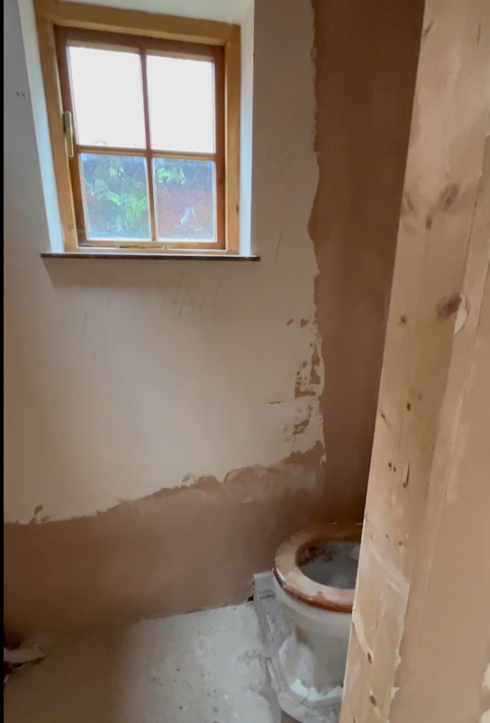 Bathroom before refurb - unfinished walls, exposed plaster