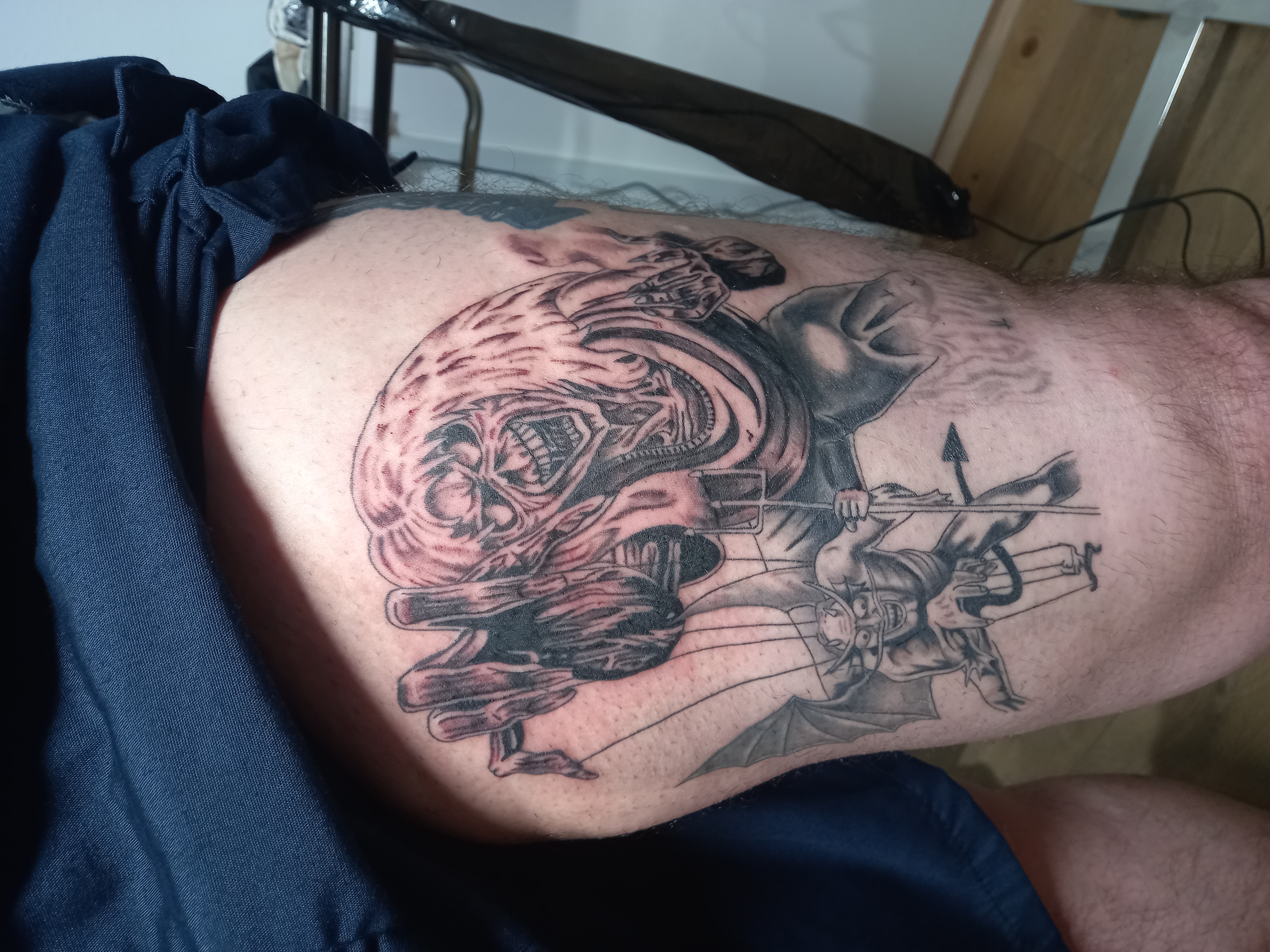 Iron Maiden Eddie with puppet devil thigh tattoo by Tori Talio