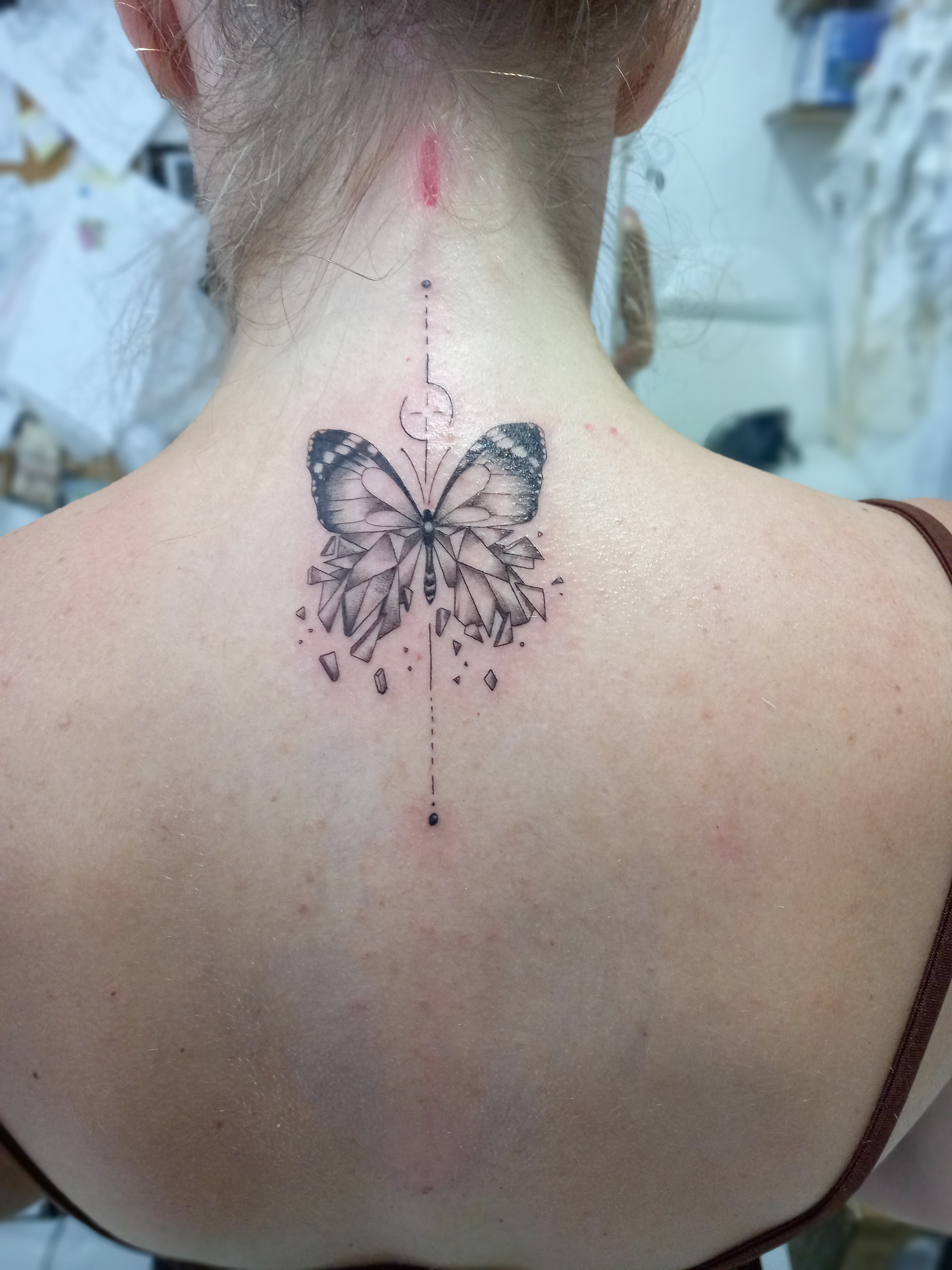 Geometric crystal butterfly back of neck tattoo by Tori Talio