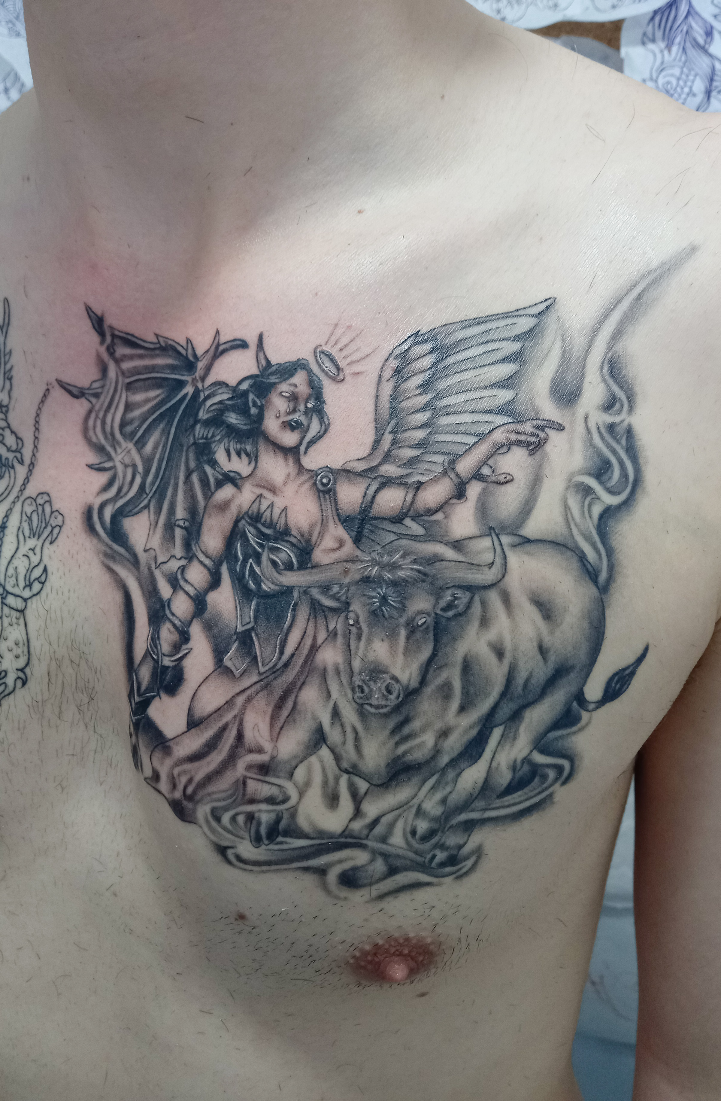 Angel with bull chest piece black and grey tattoo by Tori Talio