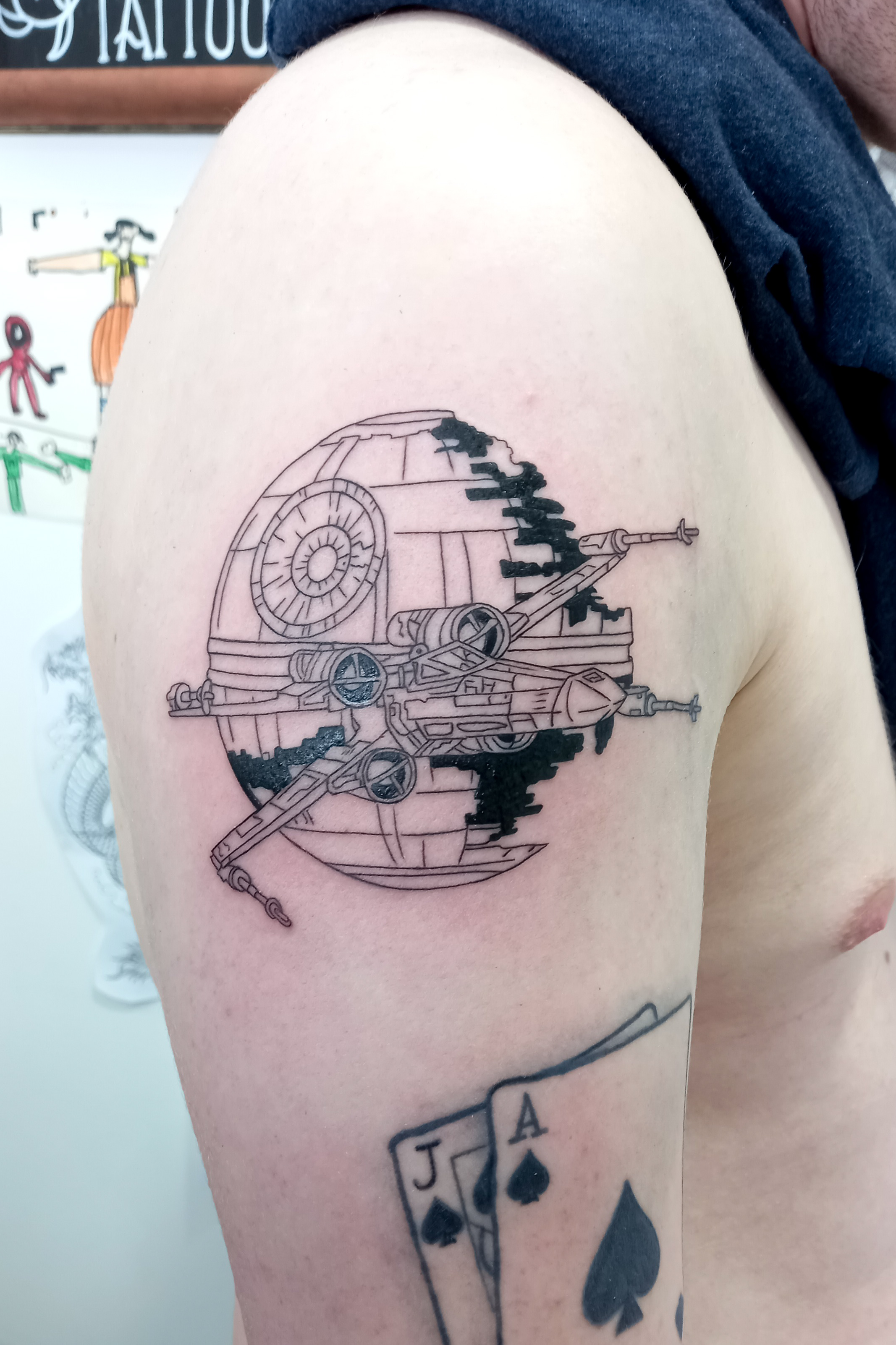 Death Star with X-Wing fine line shoulder tattoo by Tori Talio