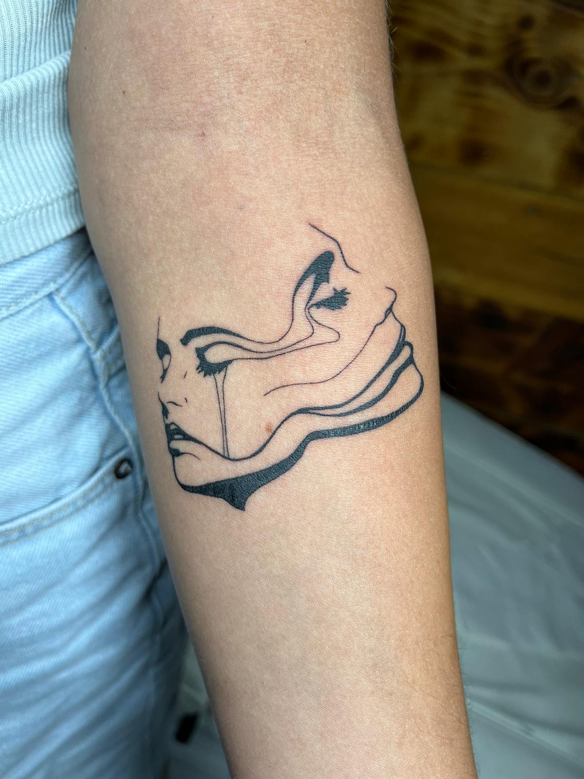 Abstract woman face linework tattoo by Luca Falzon