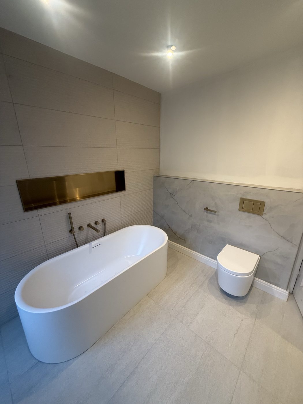 Freestanding bath with gold fixtures — bathroom renovation Stoke-on-Trent
