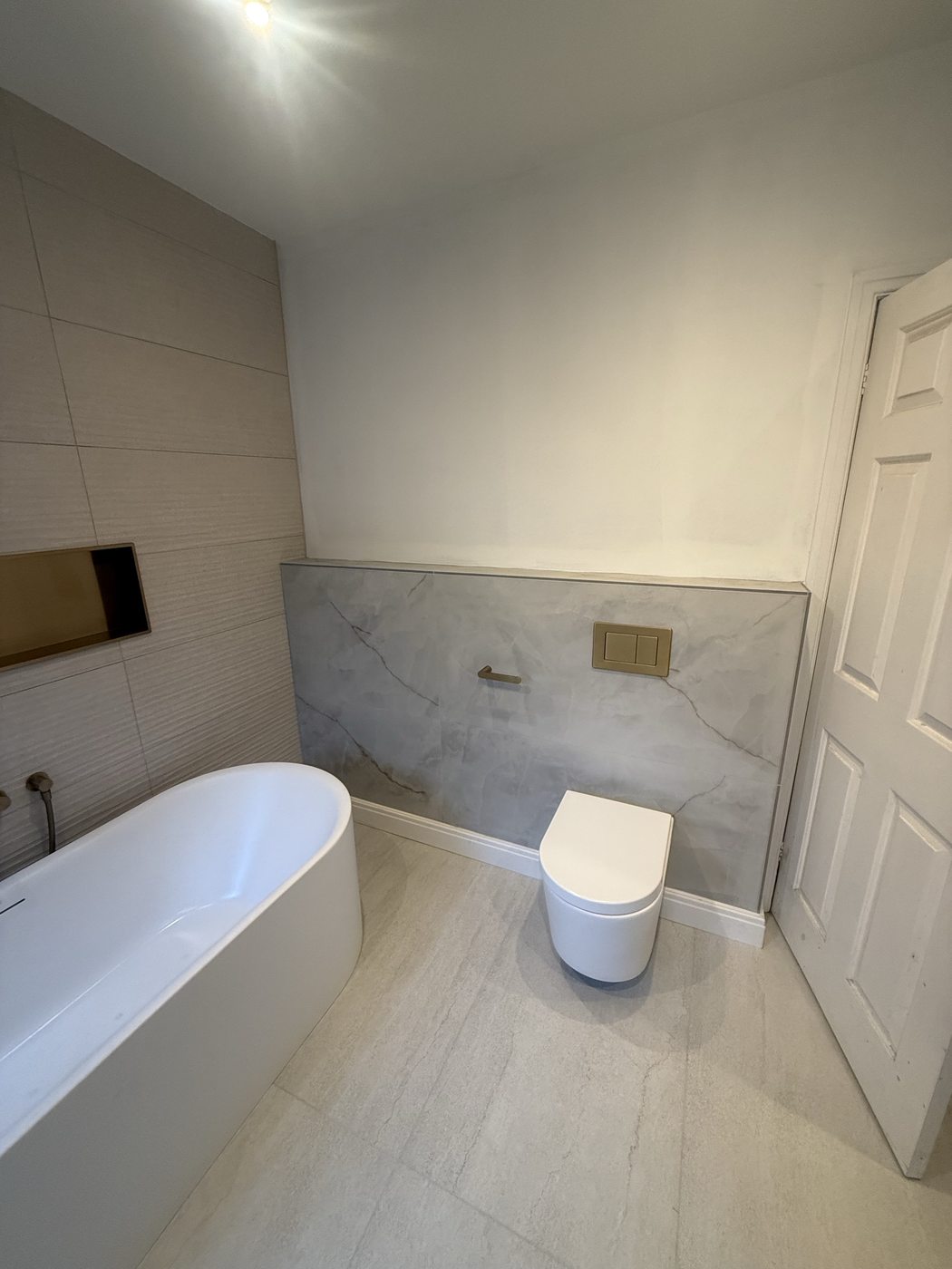 Completed — wall-hung toilet & marble feature wall
