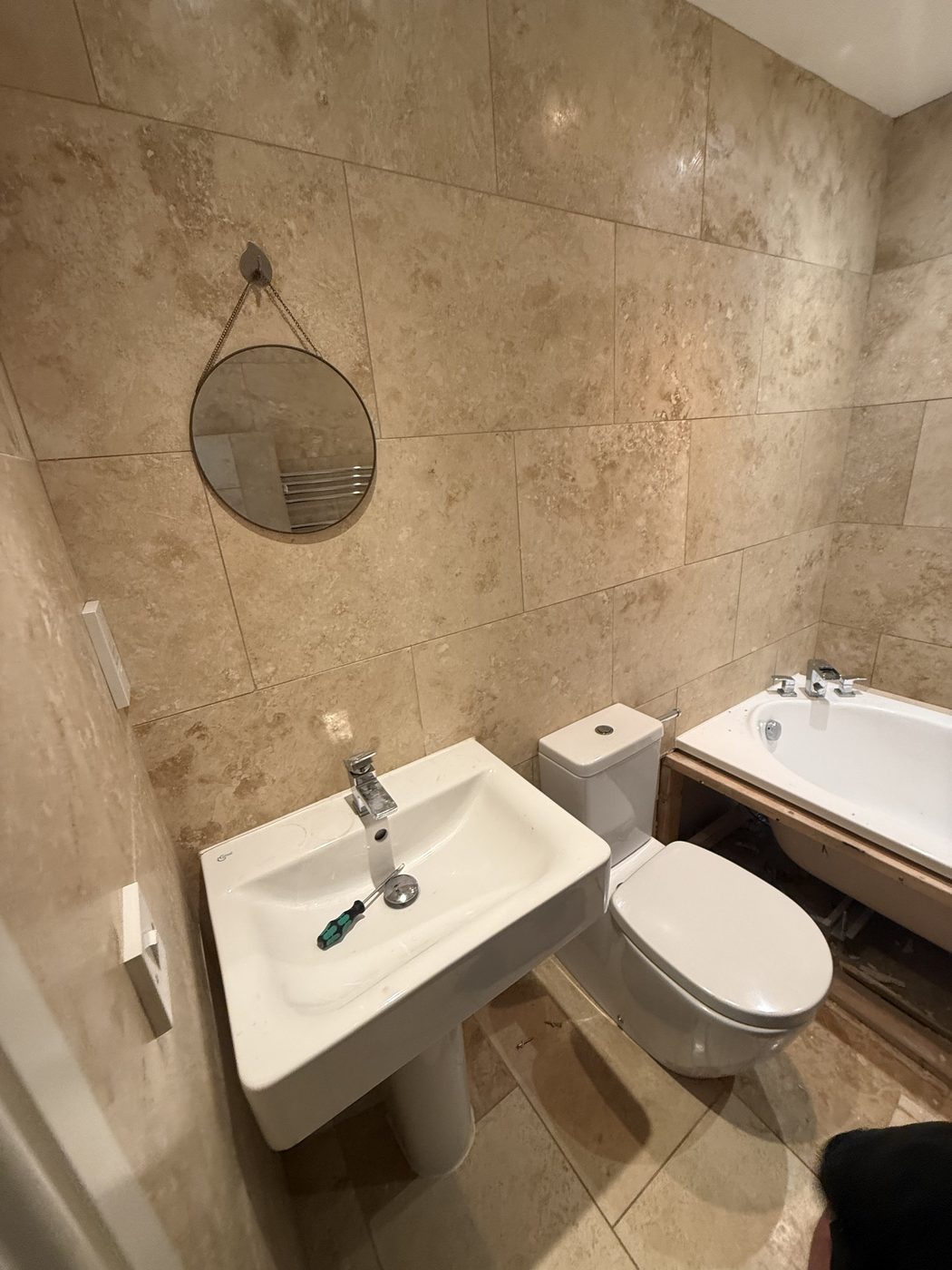 Before — dark marble bathroom