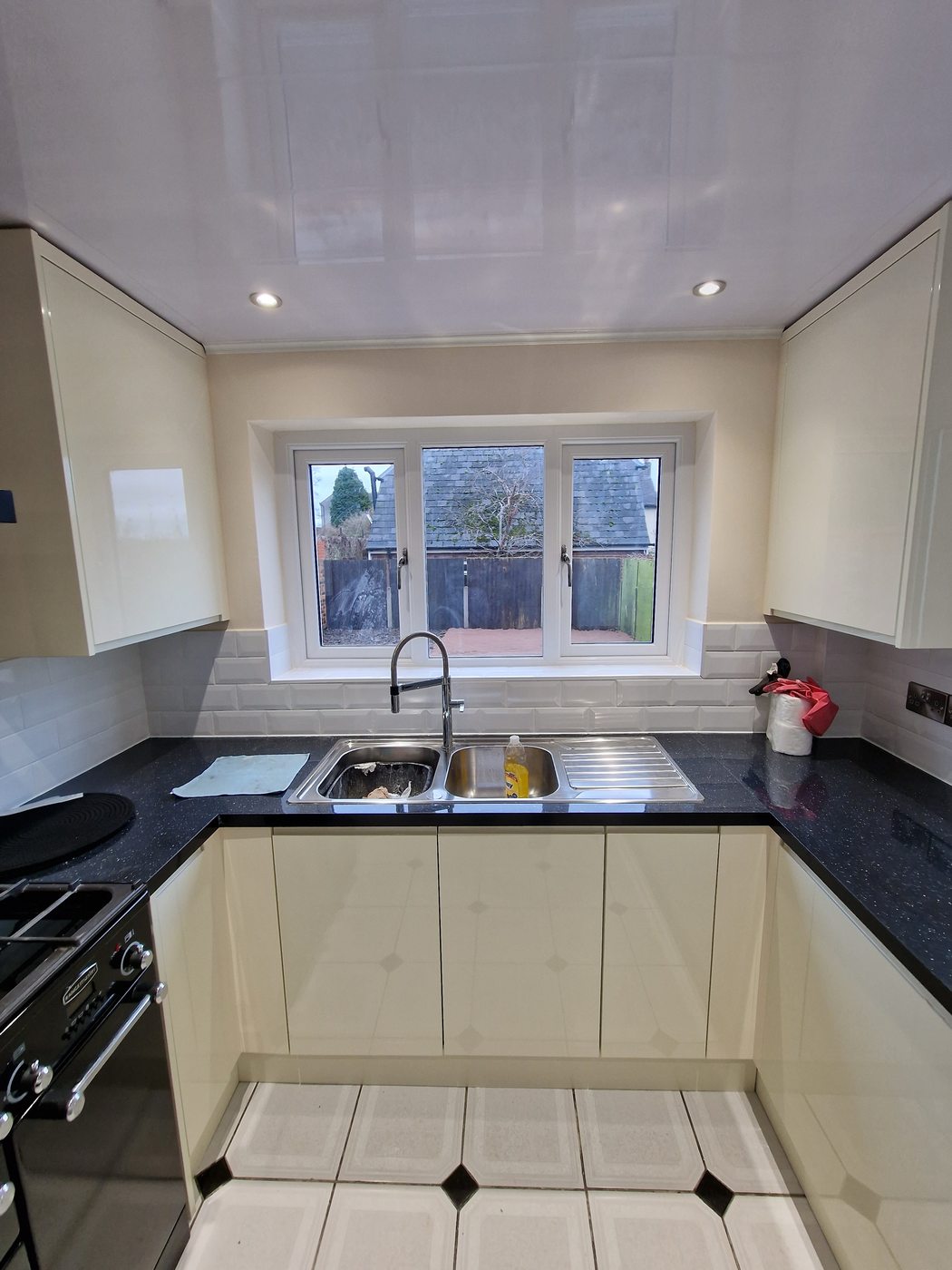 Sink area — black granite worktop & subway tiles