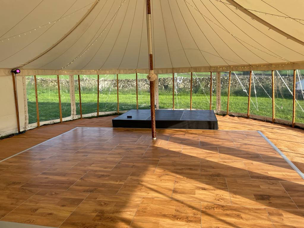 Black stage with dance floor in sailcloth marquee