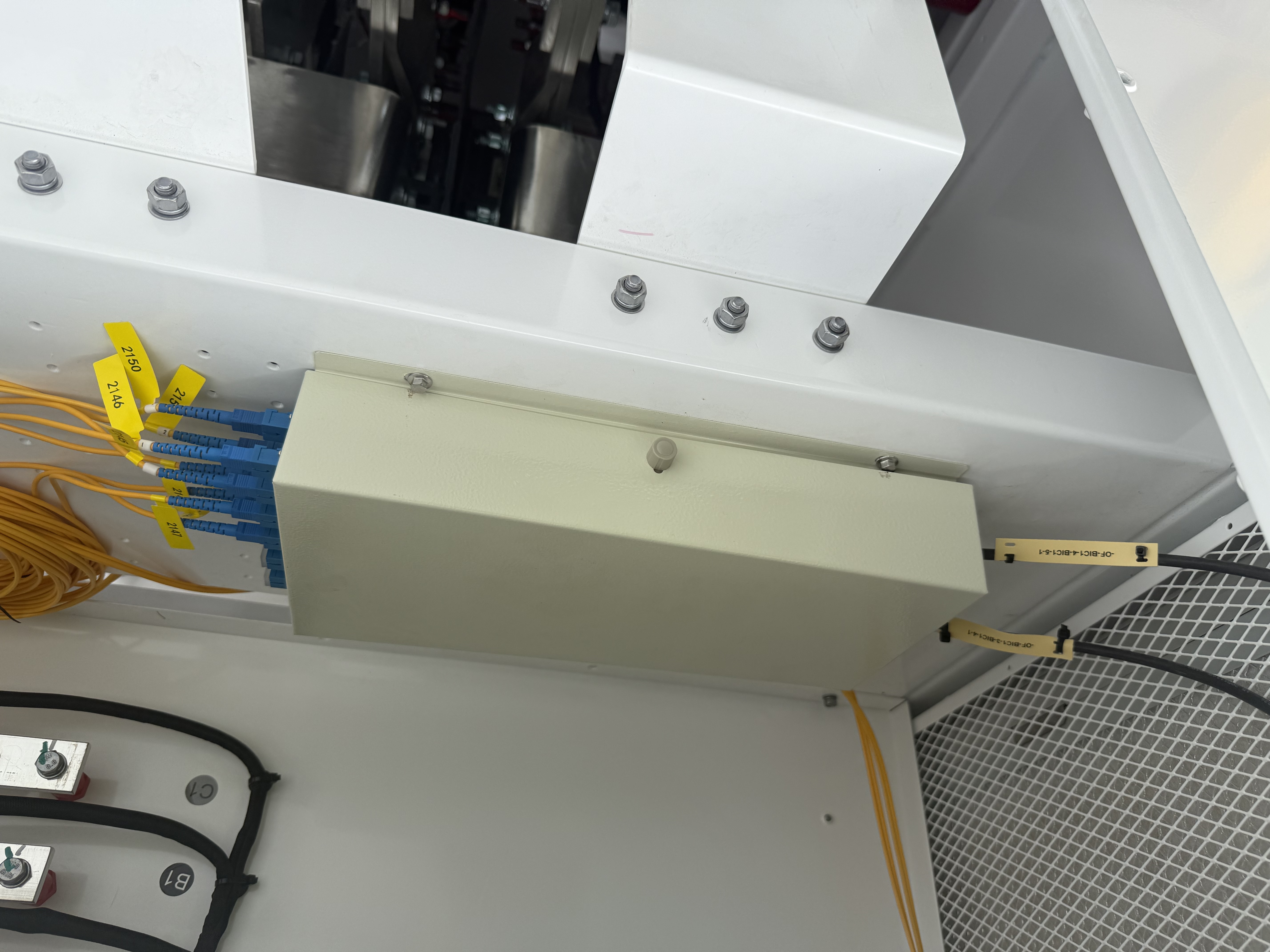 Fibre patch panel connections inside solar farm equipment, showing single-mode fibre cables and terminations