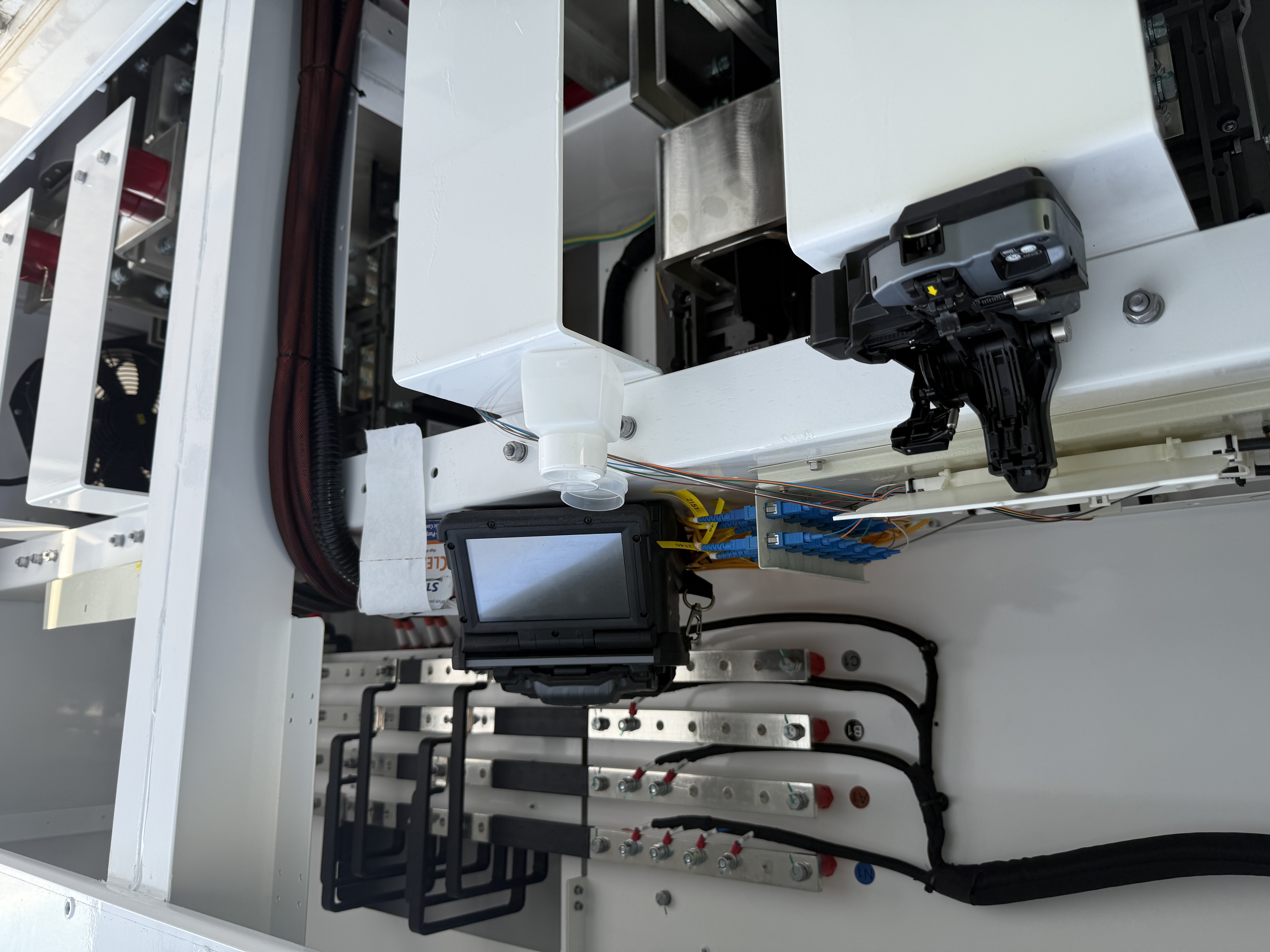 Fibre optic testing and termination work in progress inside solar farm equipment during the 49 MW solar farm project