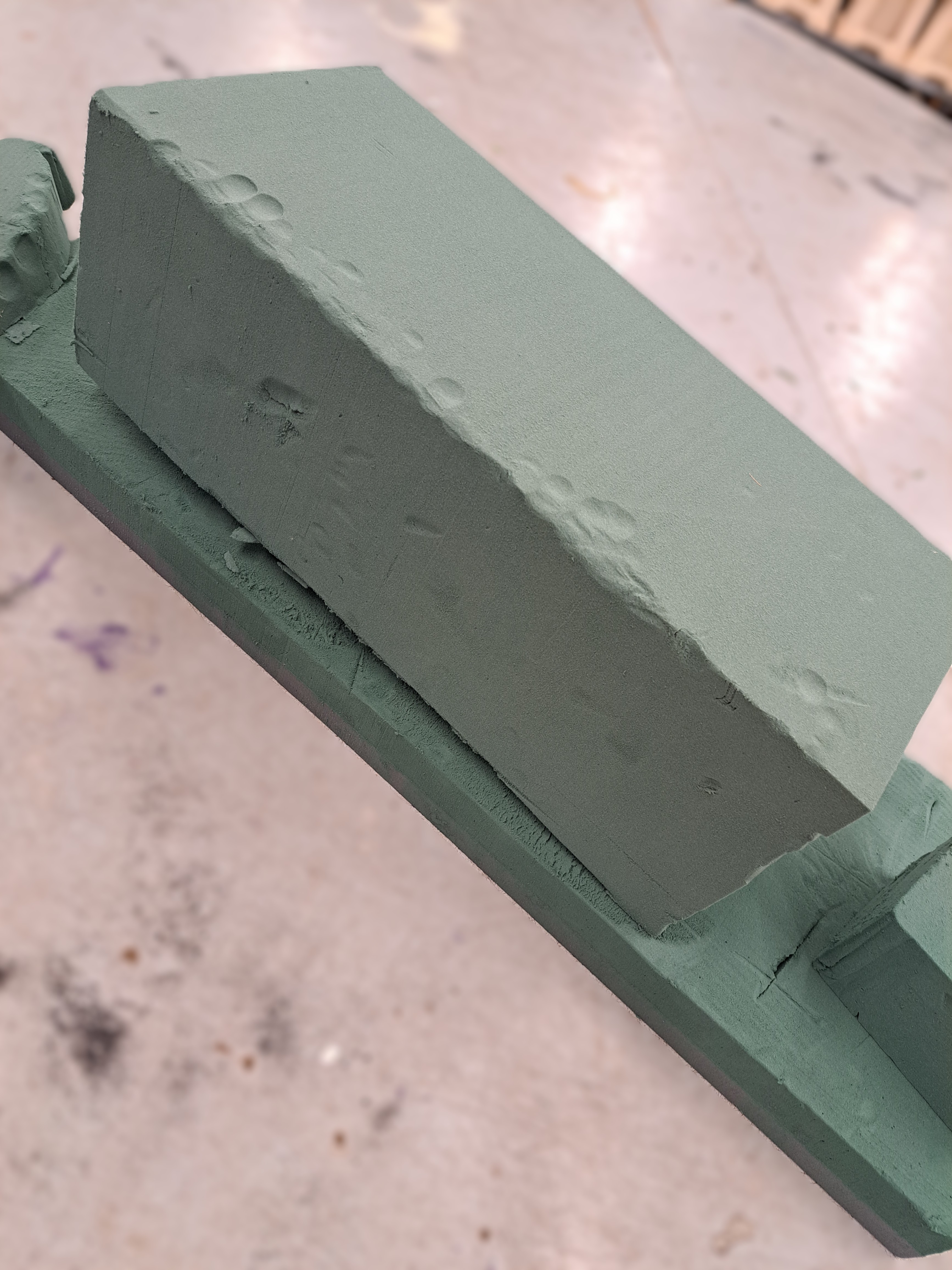 Floral foam base for gun-shaped tribute