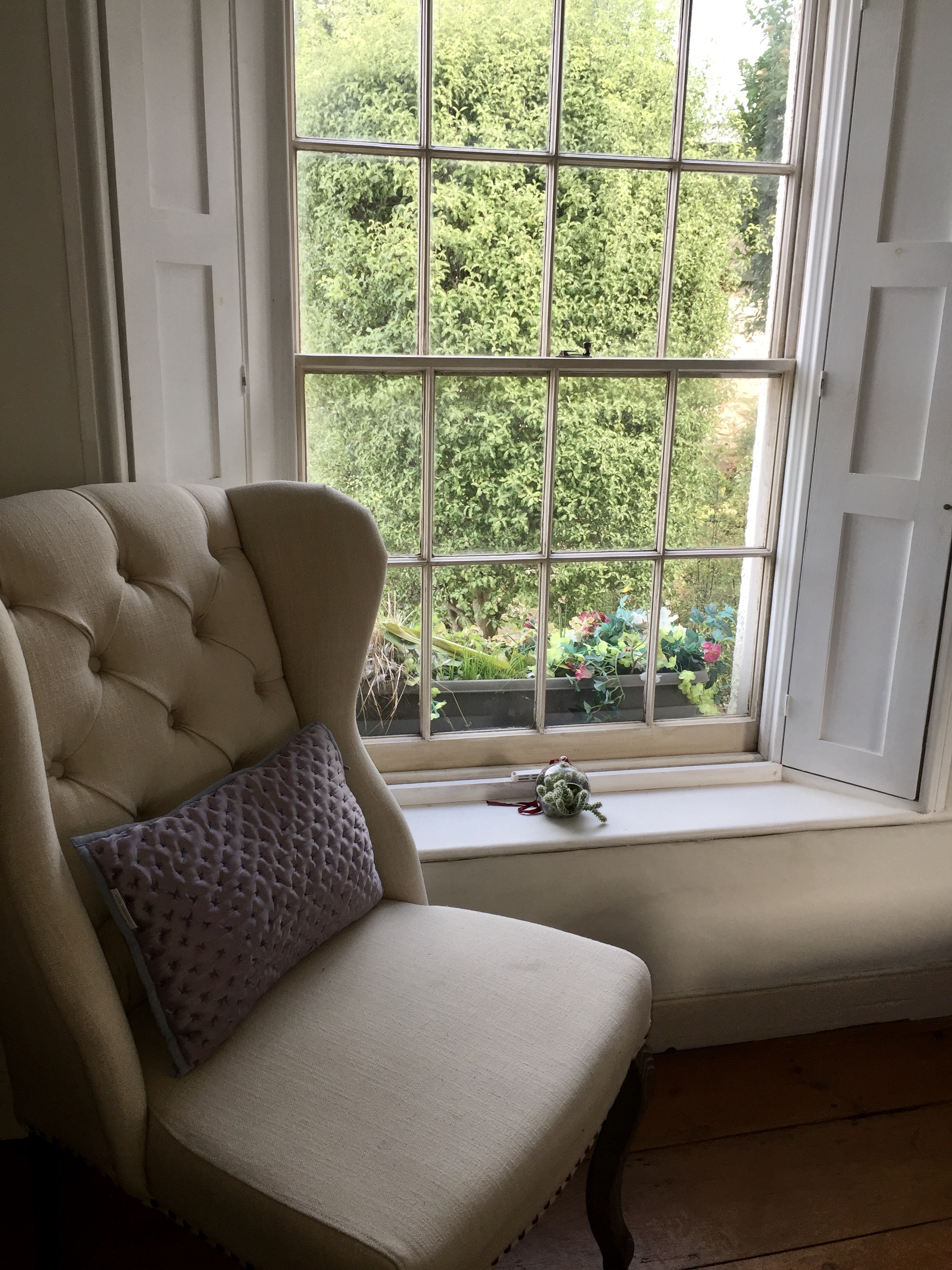 Reading nook by the sash window with garden view