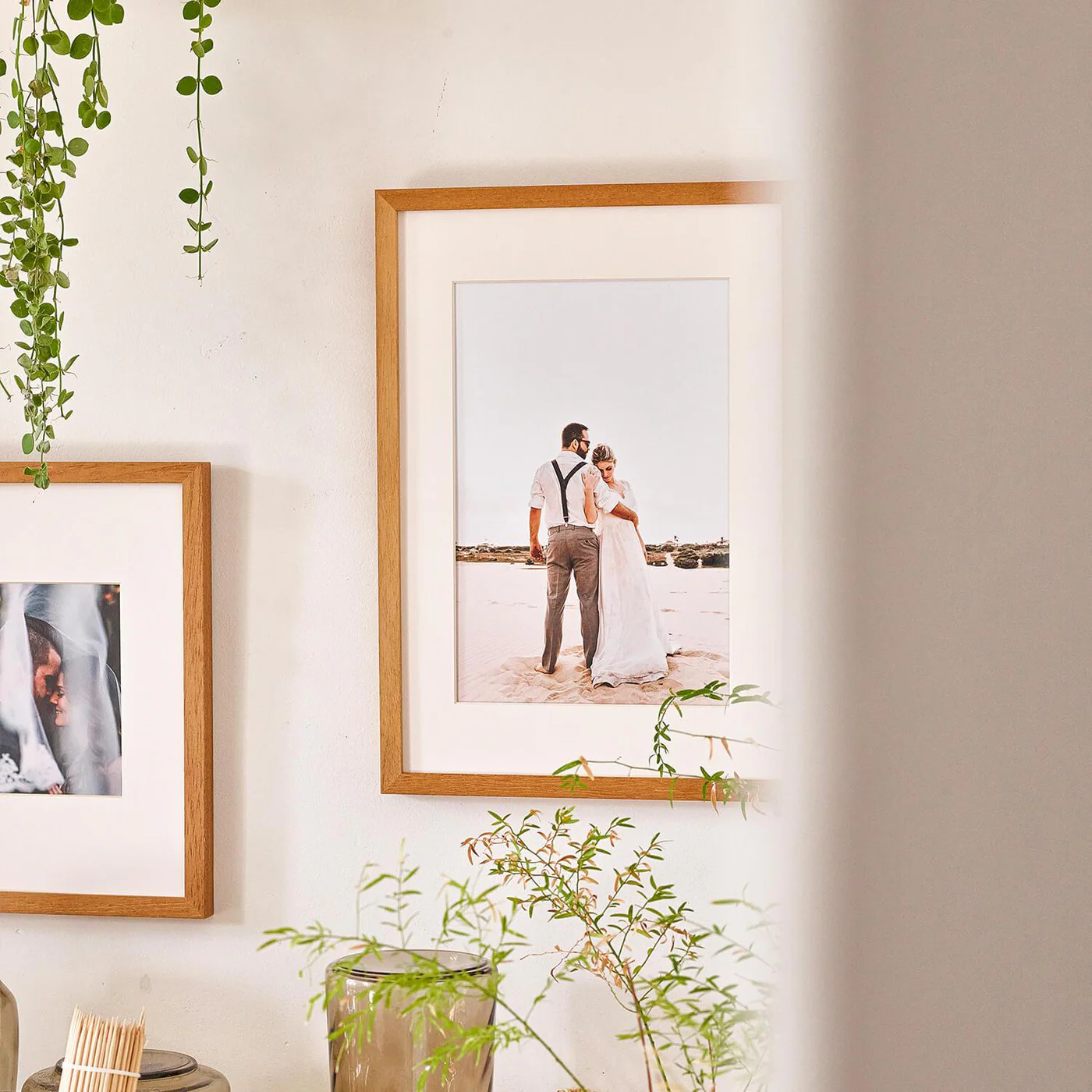 Wooden Framed Photo — duas molduras de madeira natural na parede, casamento