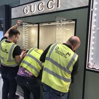 Mayfield Electrical team installing lighting at a Gucci retail unit