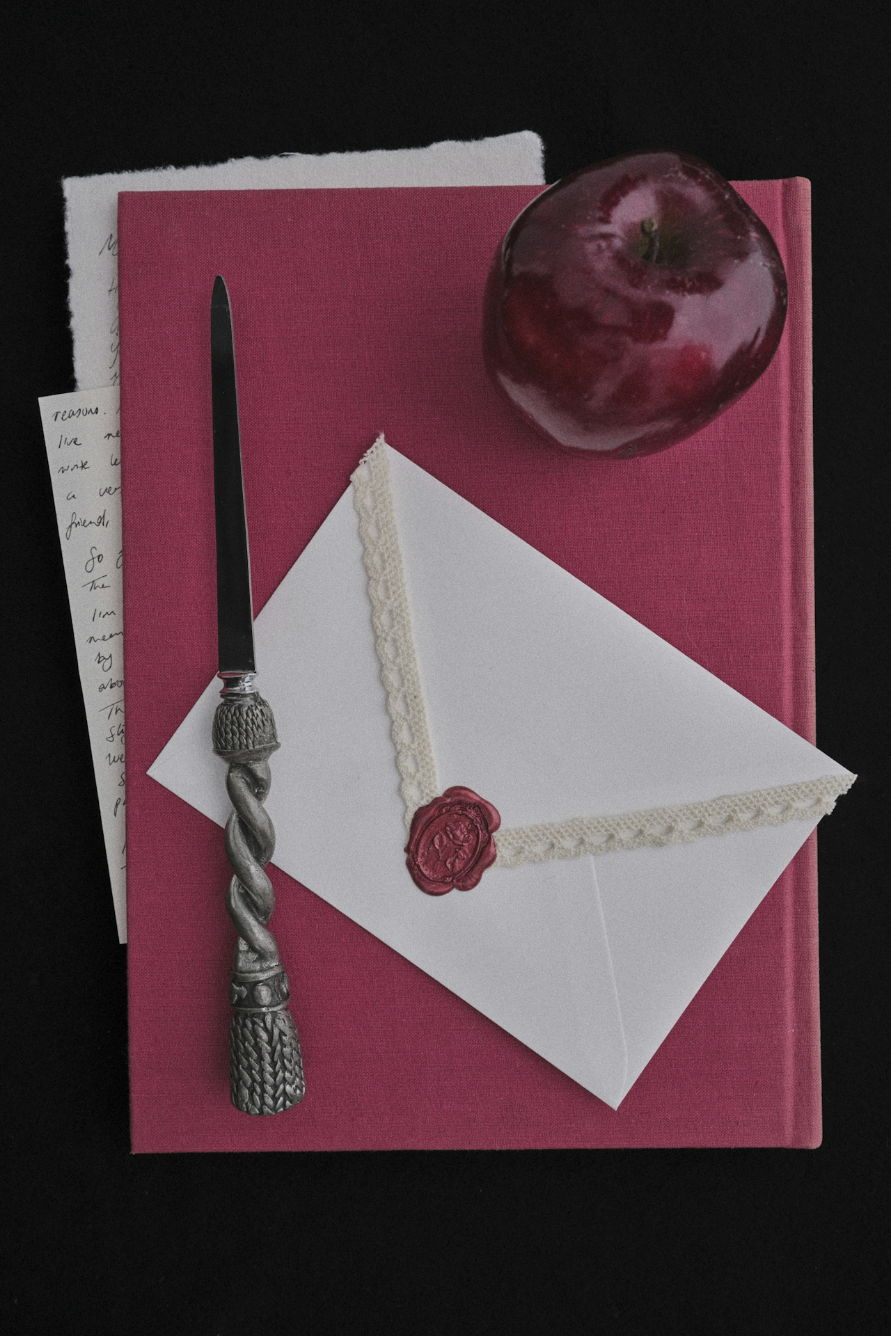 Still life with wax-sealed letter, book, and apple