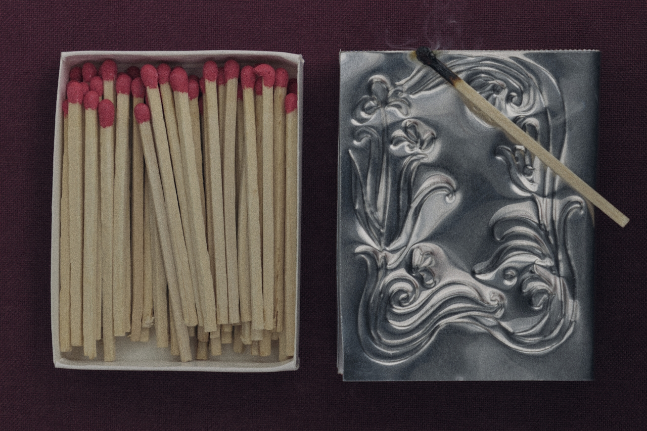 Ornate silver matchbox with pink-tipped matches