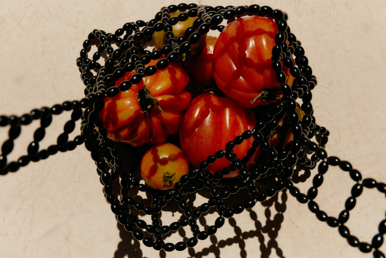 Heirloom tomatoes in a beaded basket