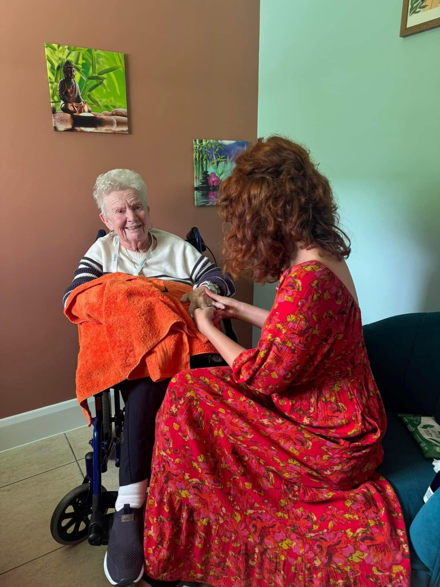 Charlie providing hand reflexology to an elderly client
