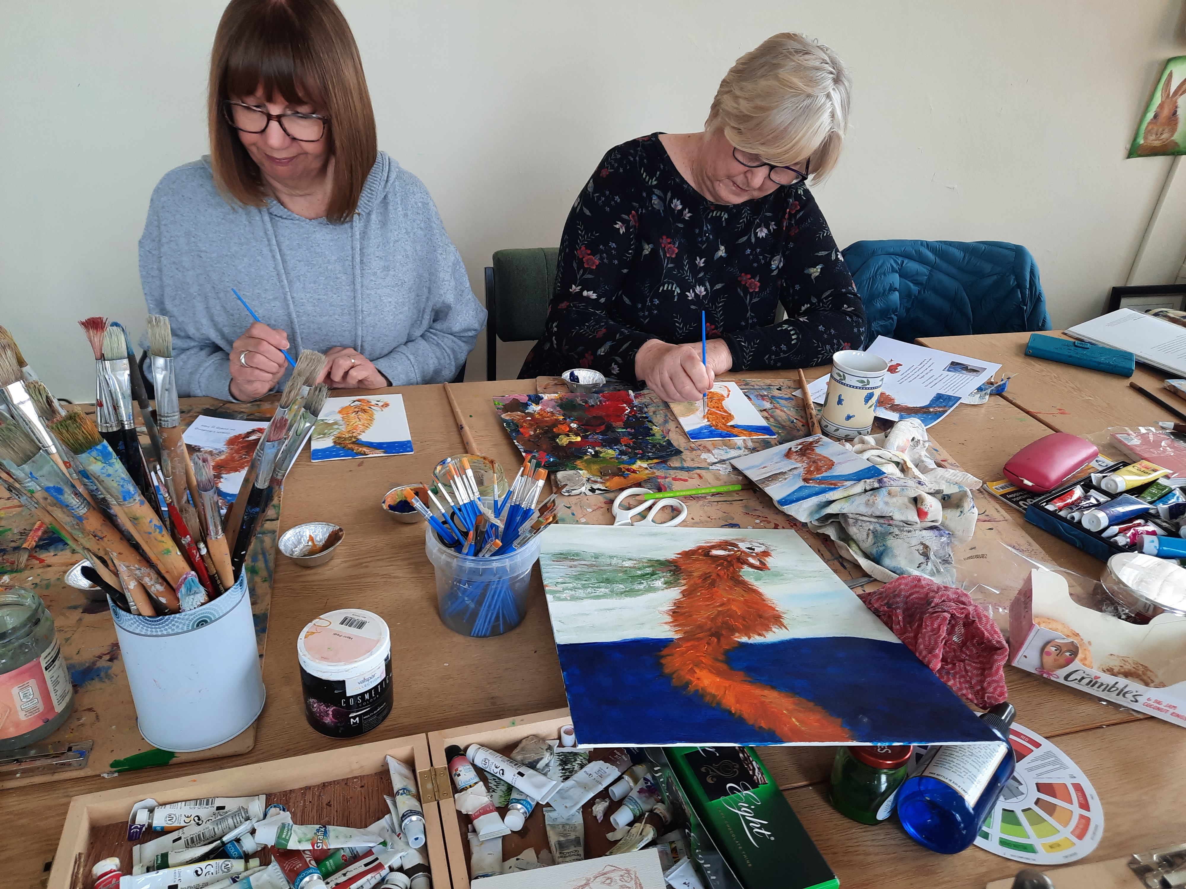 Workshop participants painting together