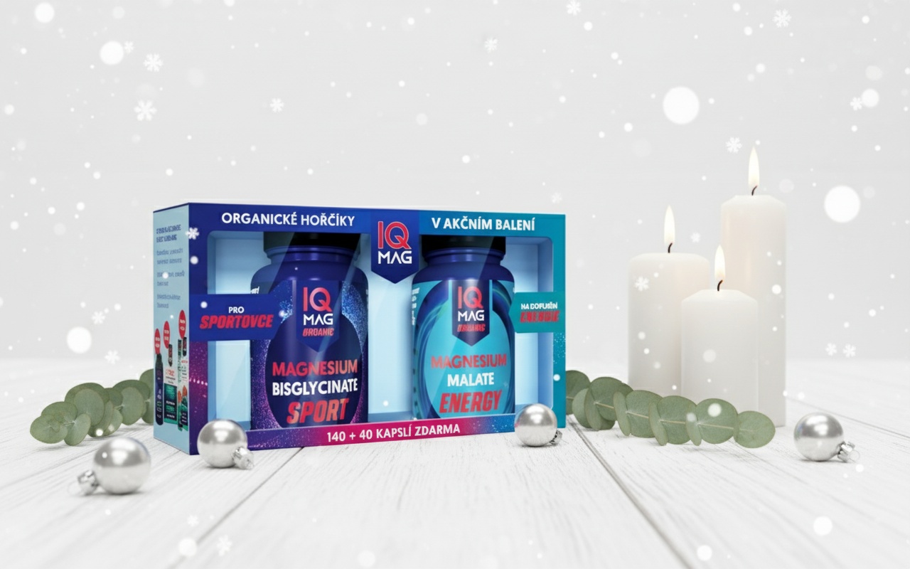 Create an elegant minimalist Christmas scene with this IQ MAG product. Place it on a clean white wooden surface with subtle Christmas elements: a few delicate silver ornaments, white candles with soft flame, eucalyptus branches, and gentle snowflakes falling. Use soft, natural lighting with a clean, modern aesthetic. The background should be soft white with subtle bokeh. Perfect for premium wellness brand marketing.