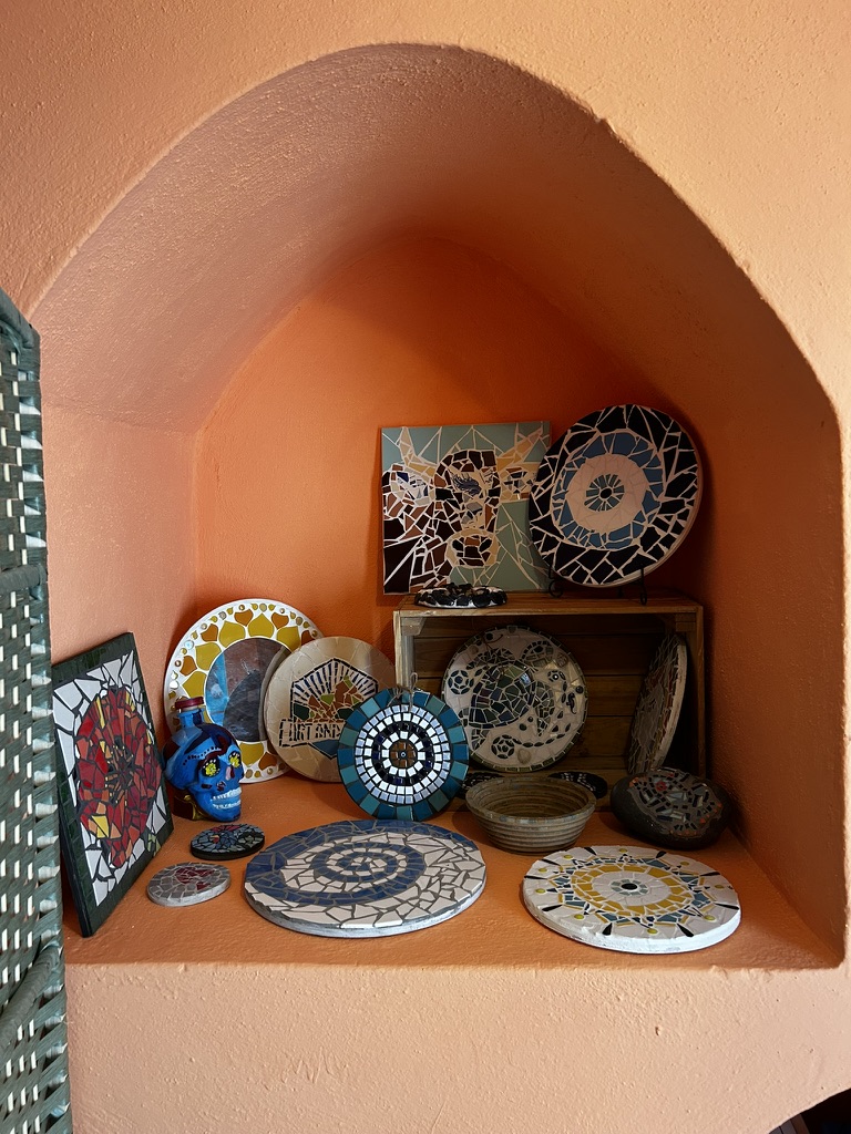 Handmade mosaic art collection in terracotta alcove
