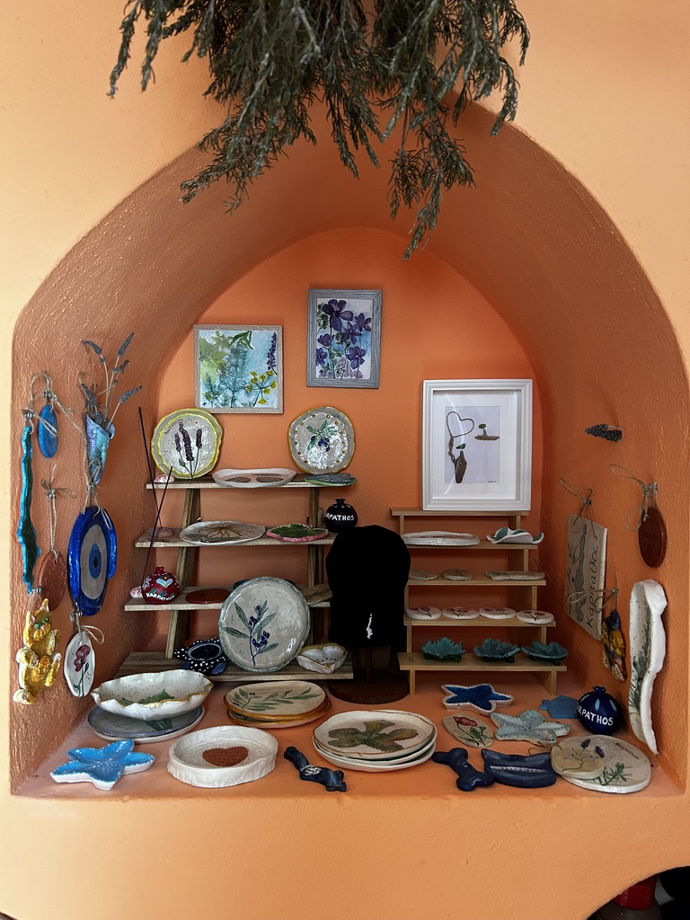Boutique shop display with handmade ceramics, botanical clay plates, and art by Renate