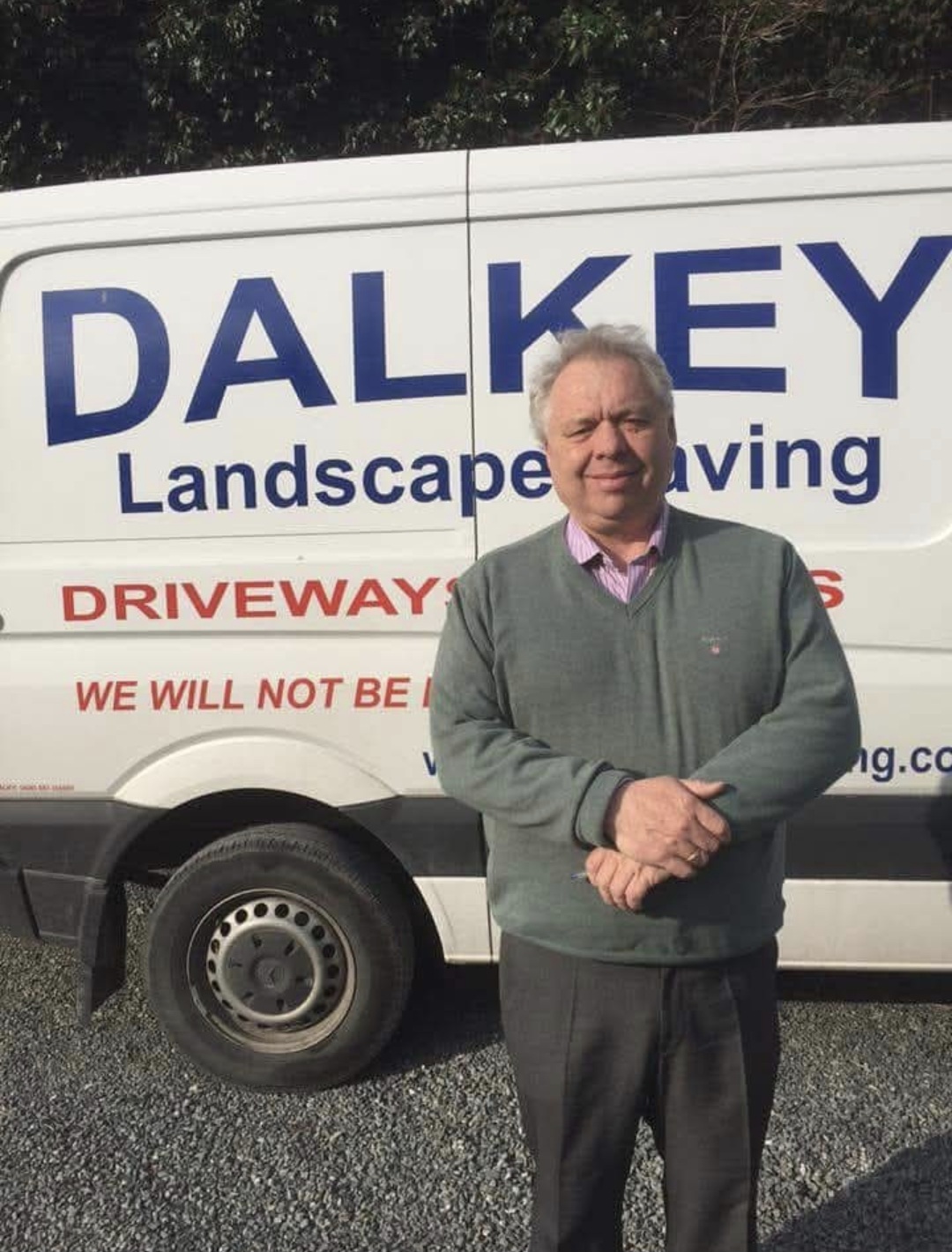 Michael Connor, founder of Dalkey Landscaping, standing in front of the company van