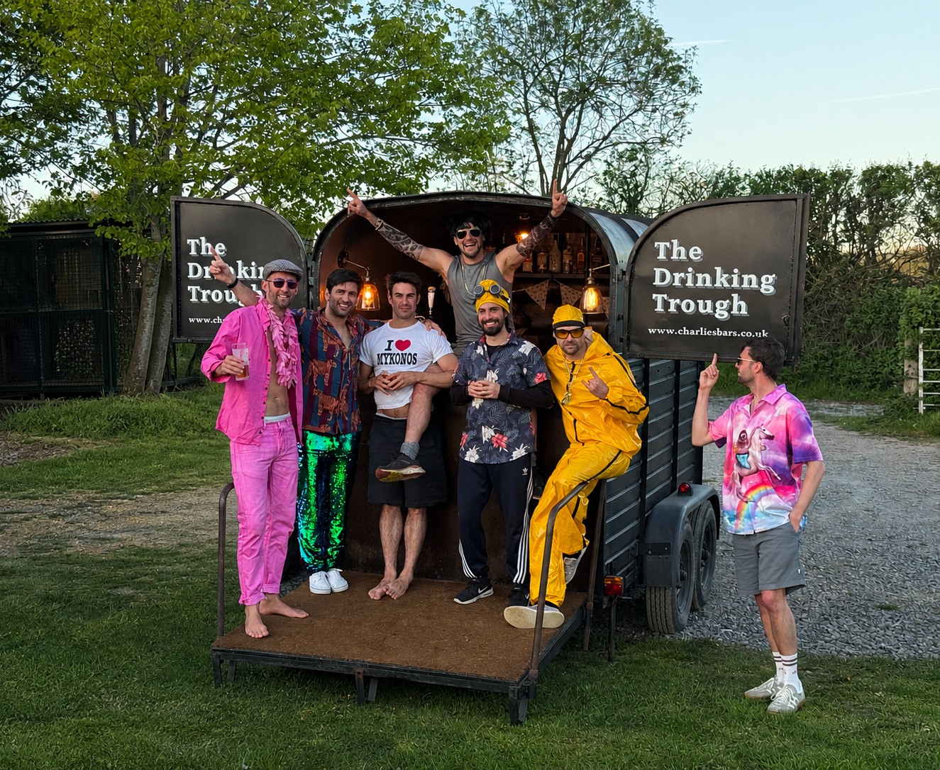 Stag do group in fancy dress celebrating at The Drinking Trough