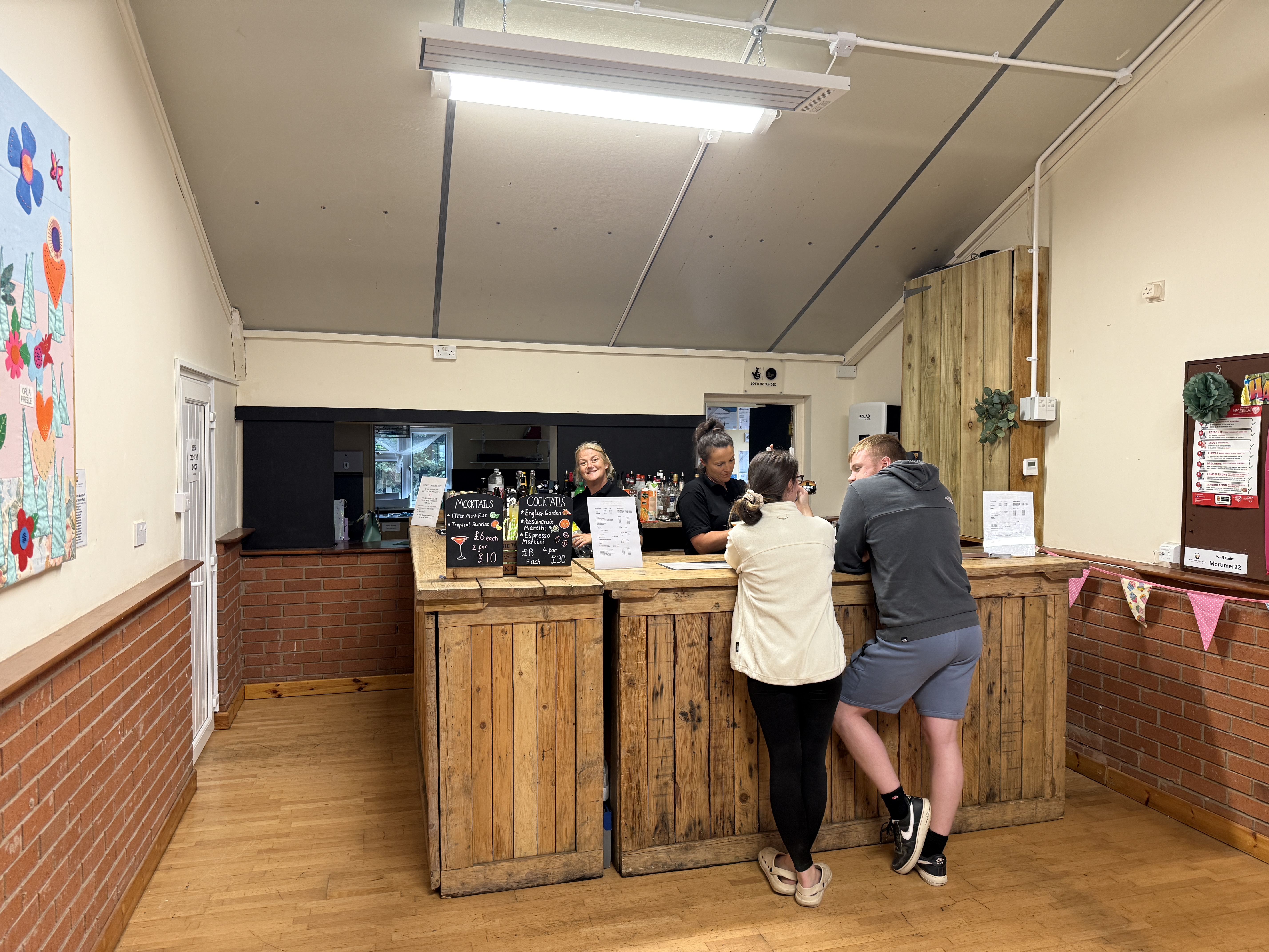 Bar staff serving guests at a village hall event