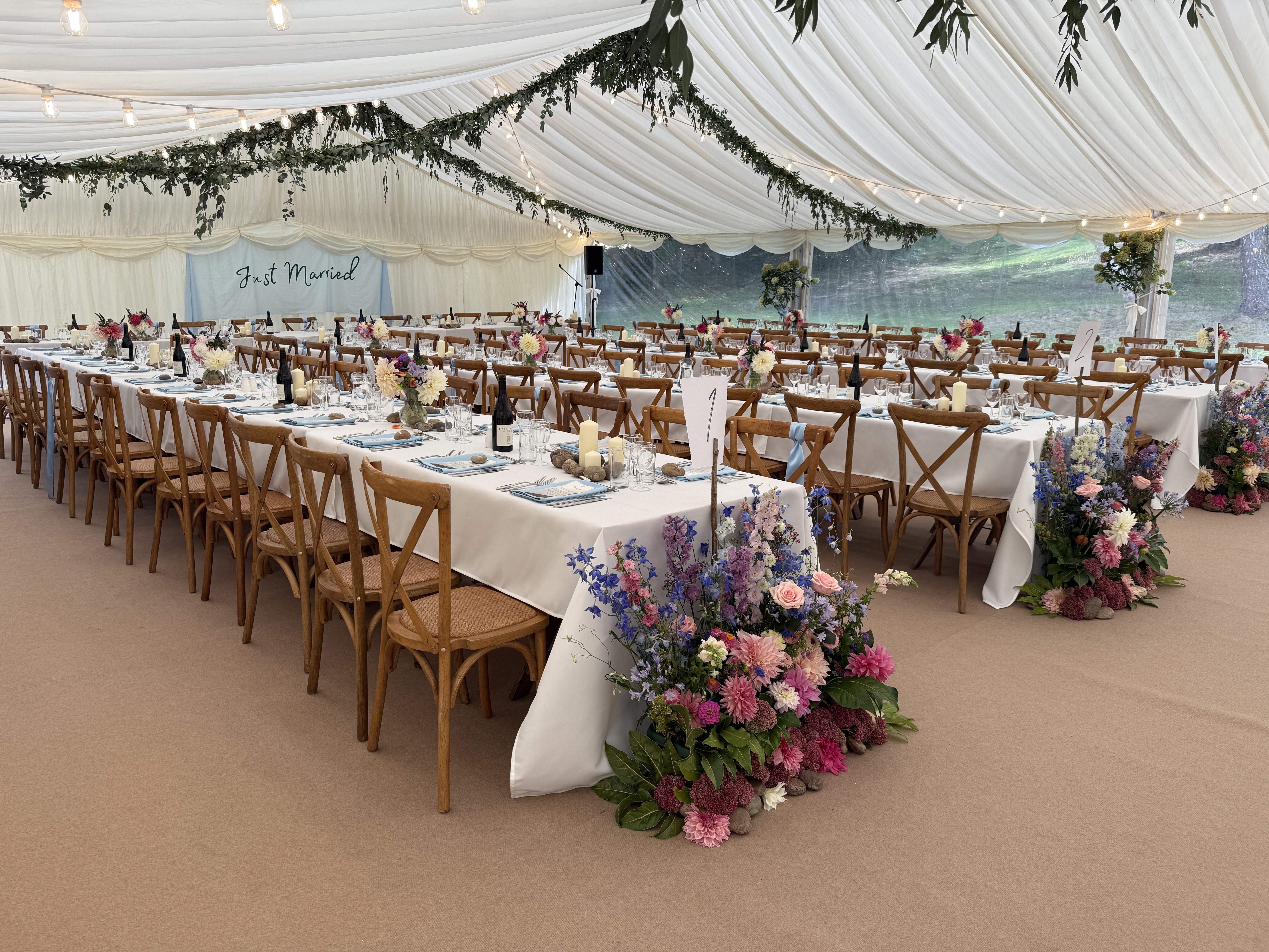 Beautiful wedding marquee with floral arrangements and table settings