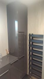 Tall gloss fitted cabinet with towel radiator by Woodgate Joinery Glasgow