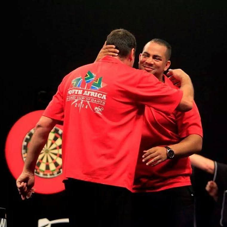 Graham Filby embracing teammate in South Africa World Cup of Darts 2014 shirt