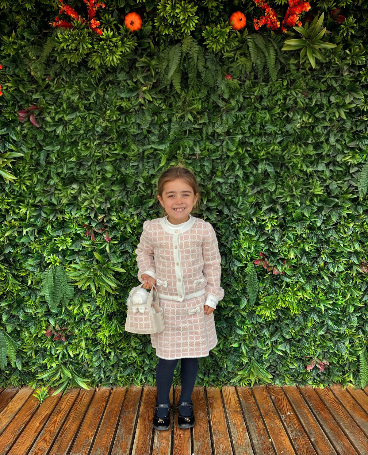 Mia smiling in a beautiful pink outfit