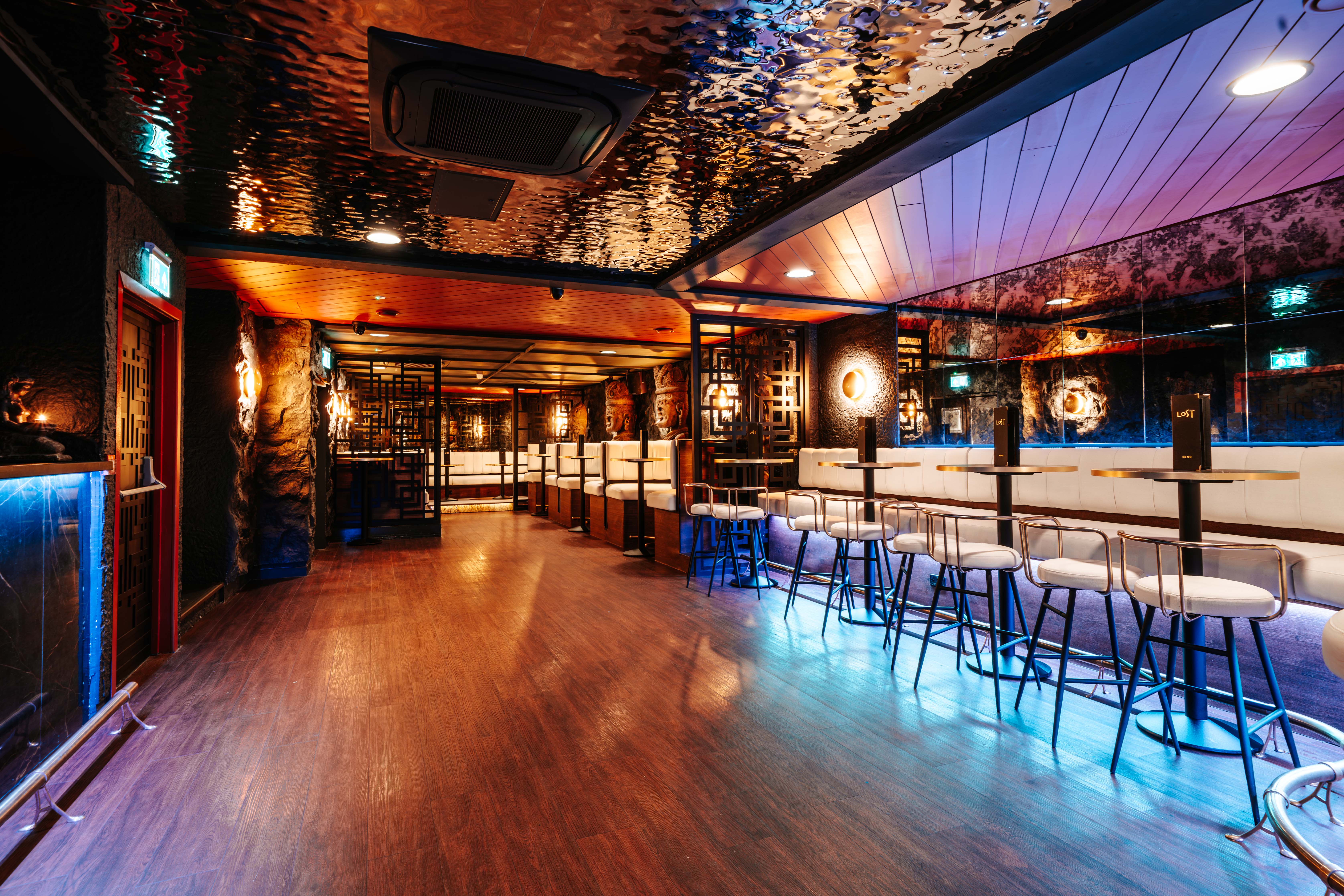 LOST Bournemouth interior showing booth seating, decorative lattice screens and atmospheric lighting across the venue floor