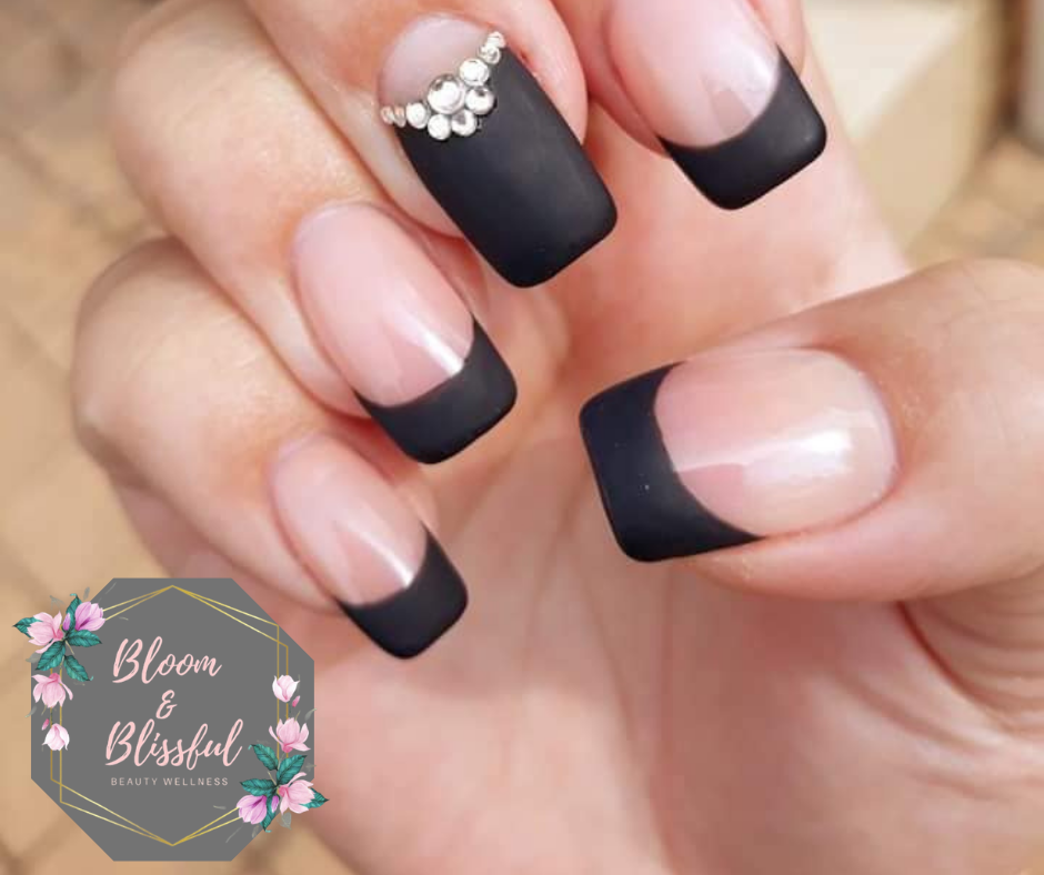Matte black French tip nails with rhinestone cluster accent by Emmie