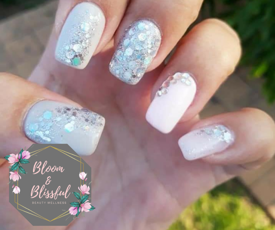 White glitter nails with rhinestone accents by Emmie