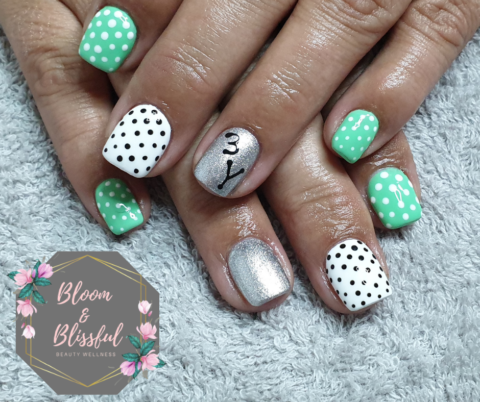 Mint green polka dot nails with silver accent by Emmie