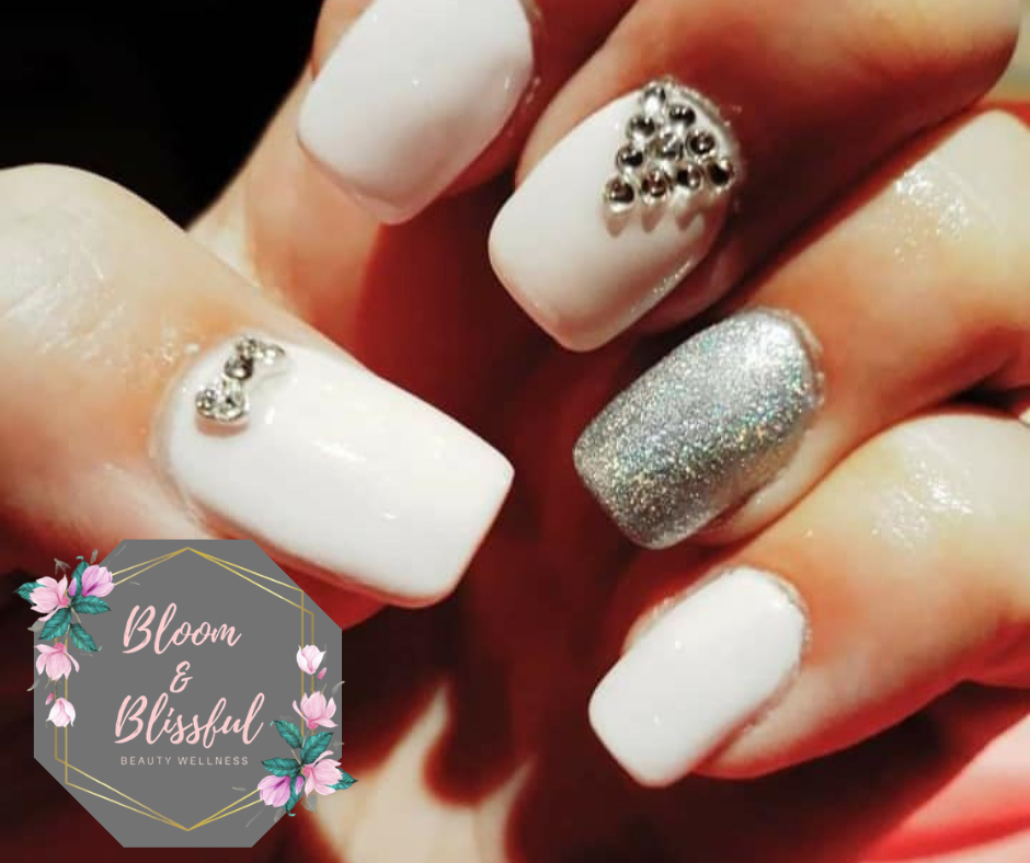 White nails with silver glitter and rhinestone accents by Emmie