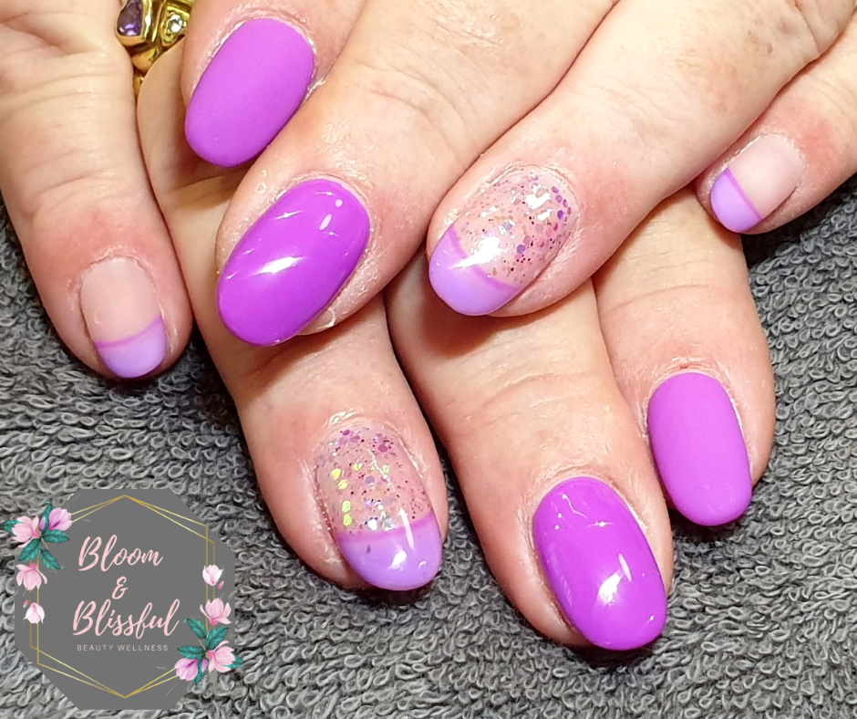 Vibrant purple nails with lavender French tips and holographic glitter accent by Emmie