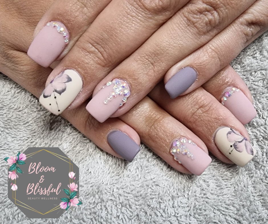 Matte mauve and grey nails with watercolour floral art and crystal accents by Emmie