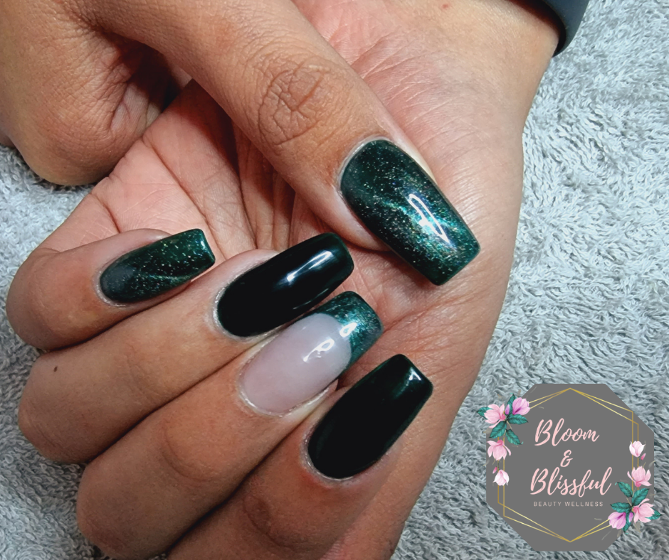 Dark emerald green cat eye nails with black accent and nude feature nail by Emmie
