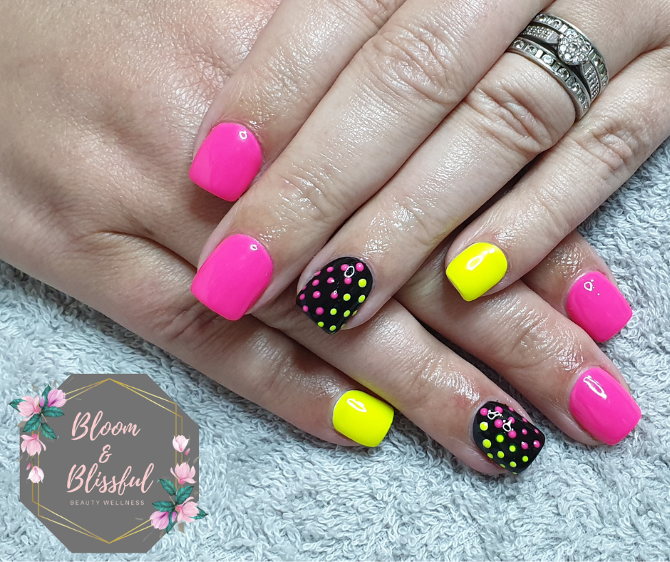 Neon pink and yellow nails with black polka dot accent by Emmie