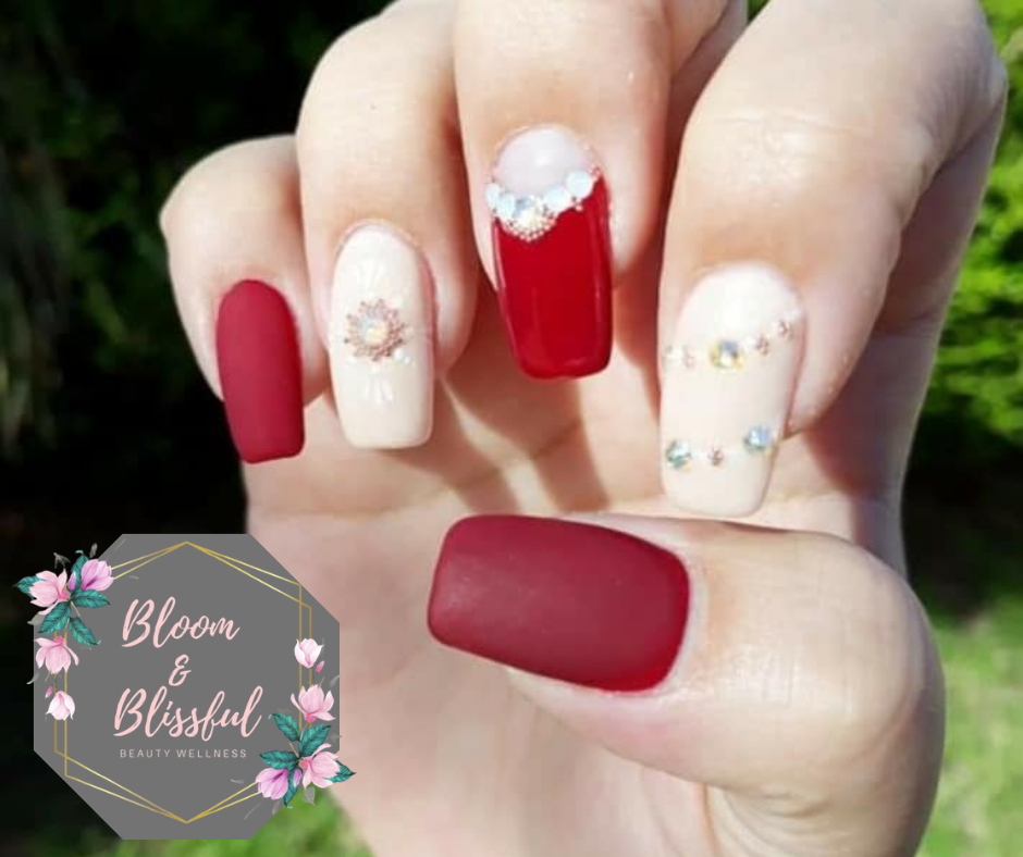Matte red and nude nails with rhinestone art by Emmie