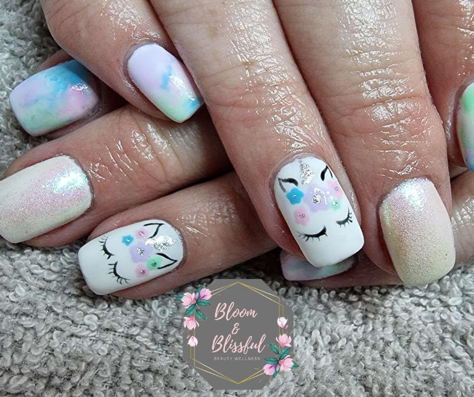 Pastel unicorn nails with watercolor tie-dye and floral unicorn face art by Emmie