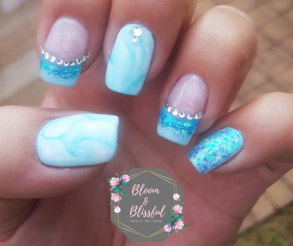 Baby blue marble nails with teal glitter and crystal accents by Emmie