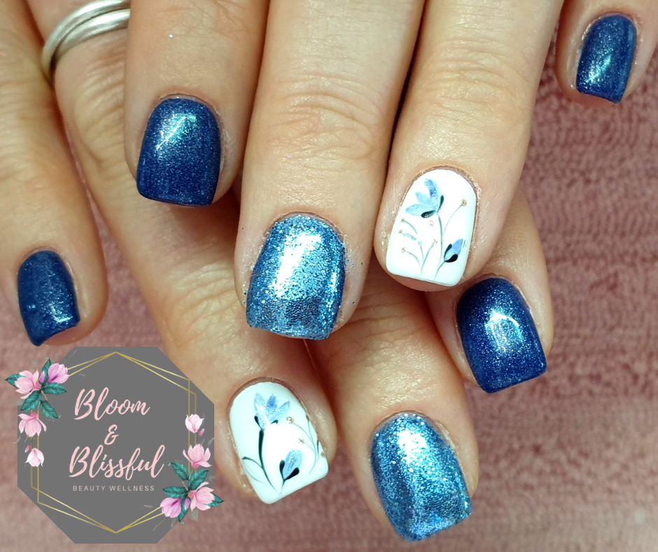 Blue glitter nails with floral accent art by Emmie