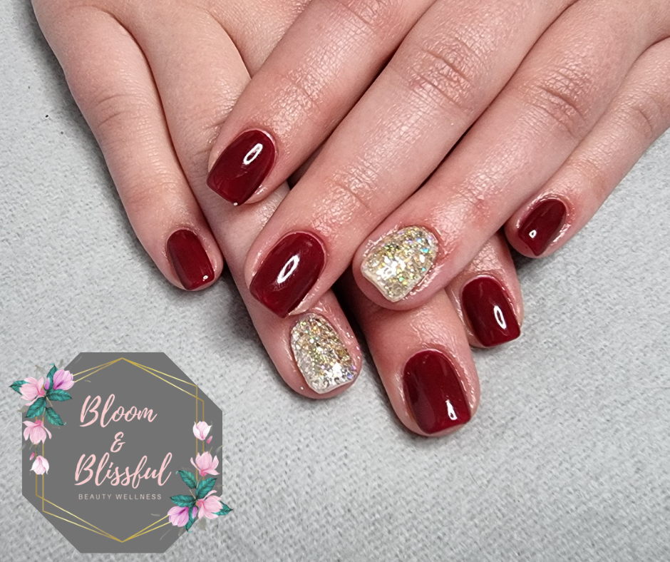 Deep burgundy red short nails with gold glitter accent by Emmie