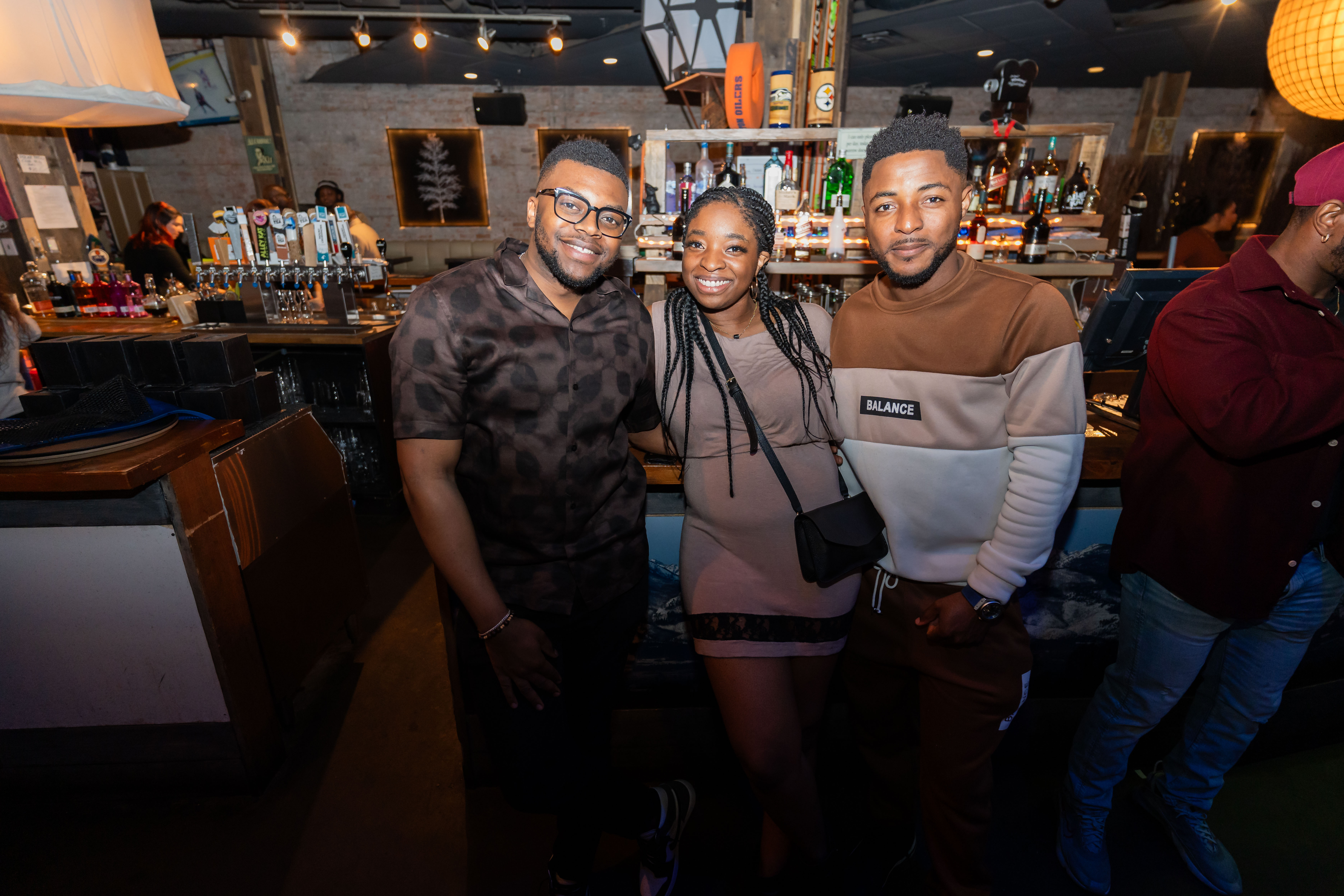 Friends enjoying a La Connexional event at the bar