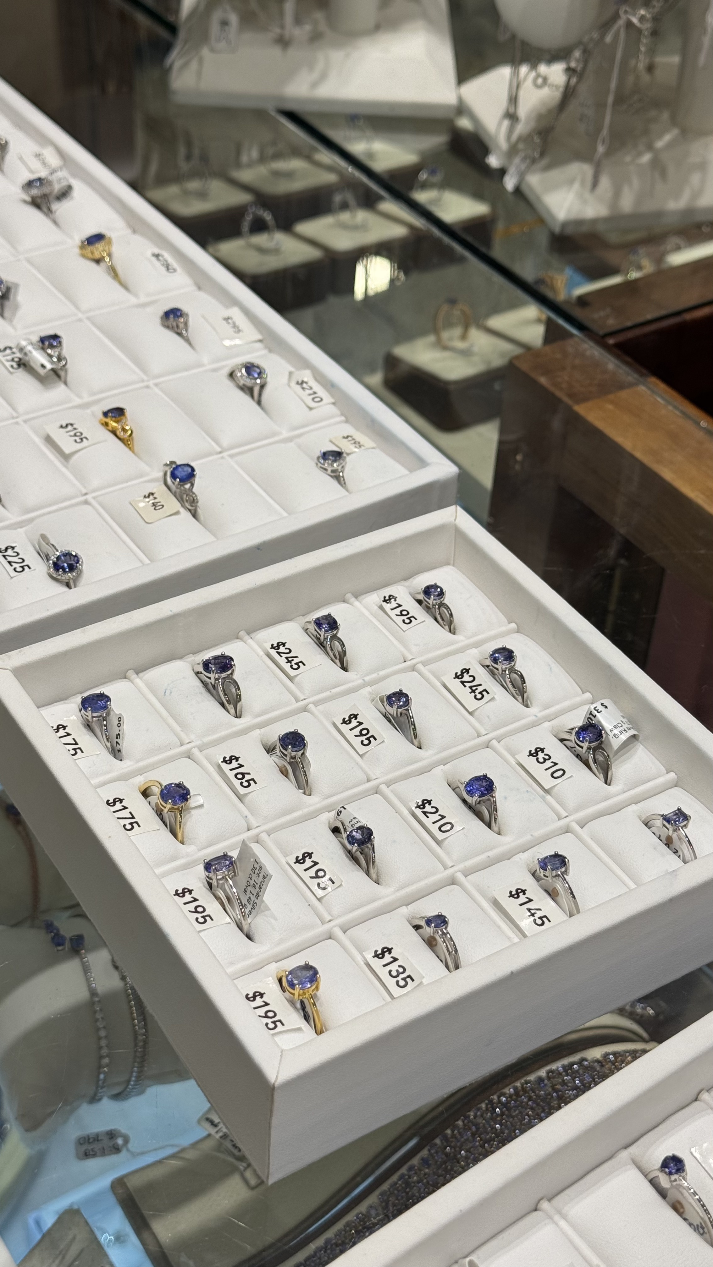 Tanzanite rings display case with various styles and prices in Zanzibar