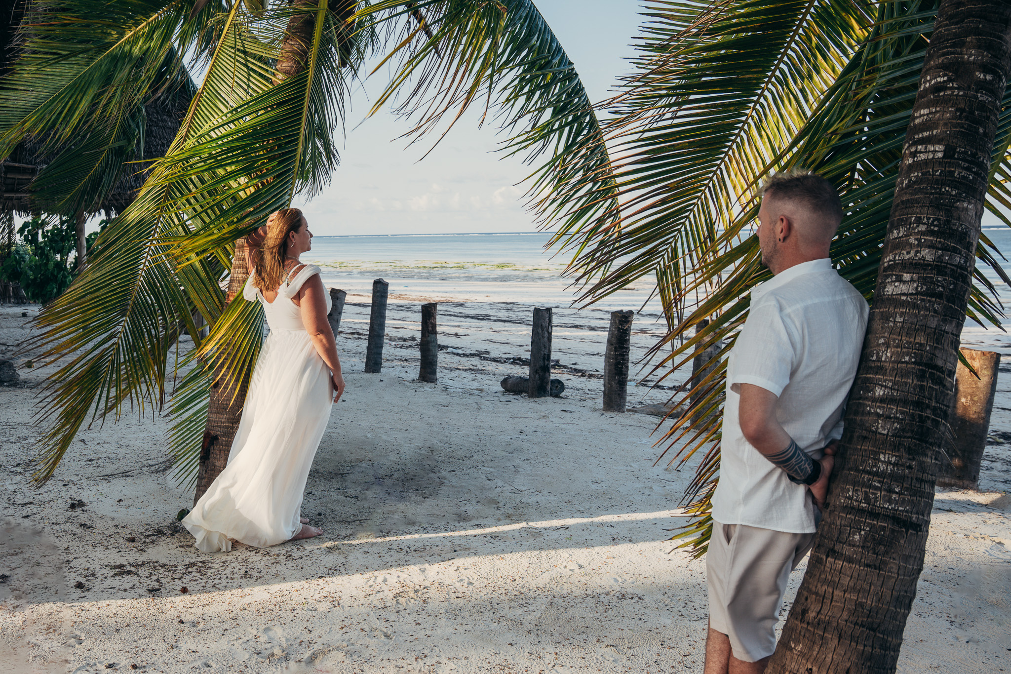 Couple under palm trees on Zanzibar beach - golden hour session